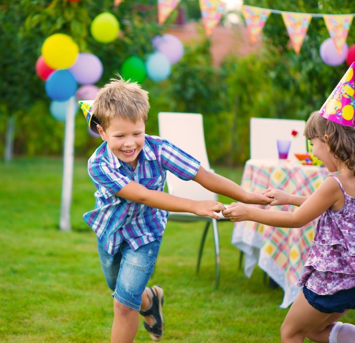 Two little kids celebrating birthday dancing roundelay