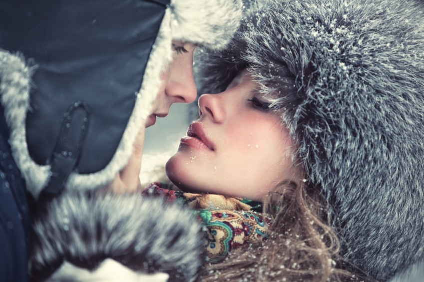 Young kissing couple outdoors portrait.